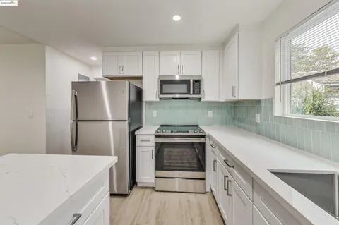 a kitchen with a refrigerator a sink and a stove