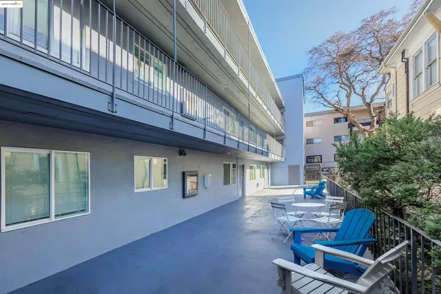 a front view of a house with outdoor seating and stairs