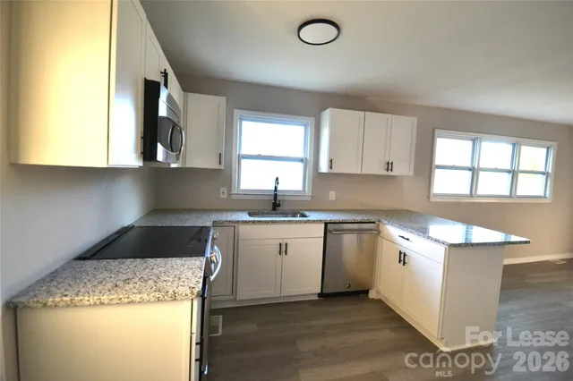 a kitchen with a sink stove and cabinets
