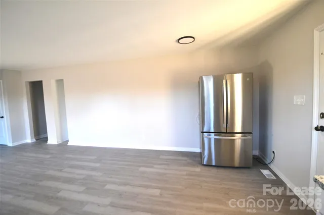 a view of a kitchen with a sink and refrigerator
