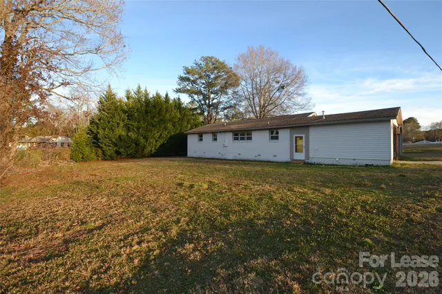 a view of house with yard