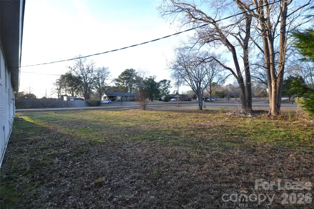 a backyard of apartments with large trees
