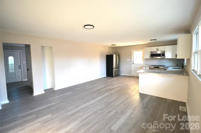 a view of kitchen view wooden floor and electronic appliances