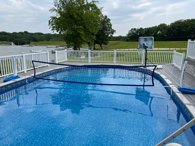 a view of a deck with a table and chairs next to a yard