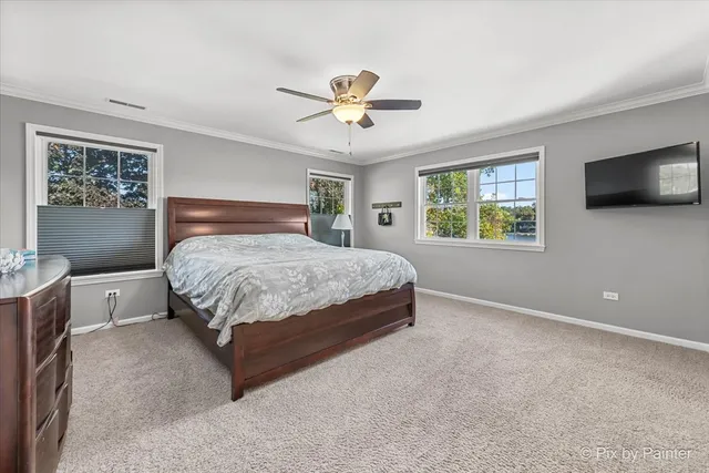 a bedroom with a bed a window and a flat screen tv