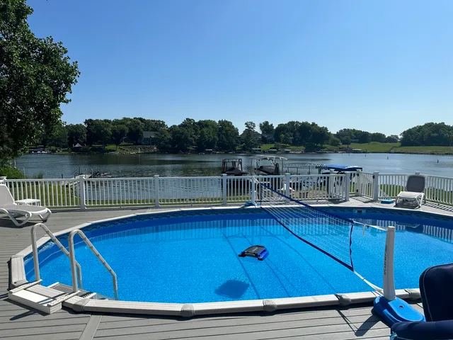 a view of a lake with couches and wooden floor