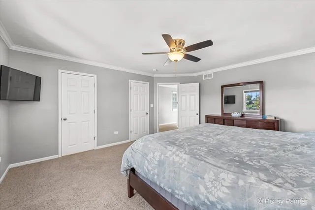 a spacious bedroom with a bed and a flat screen tv