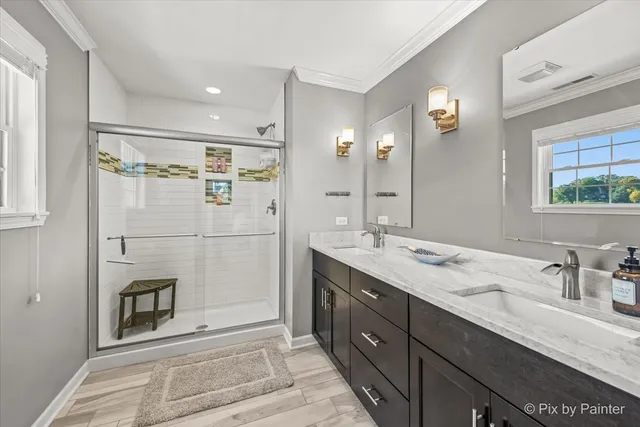 a spacious bathroom with a shower sink and mirror