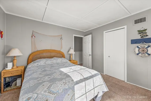 a bedroom with a bed and a lamp