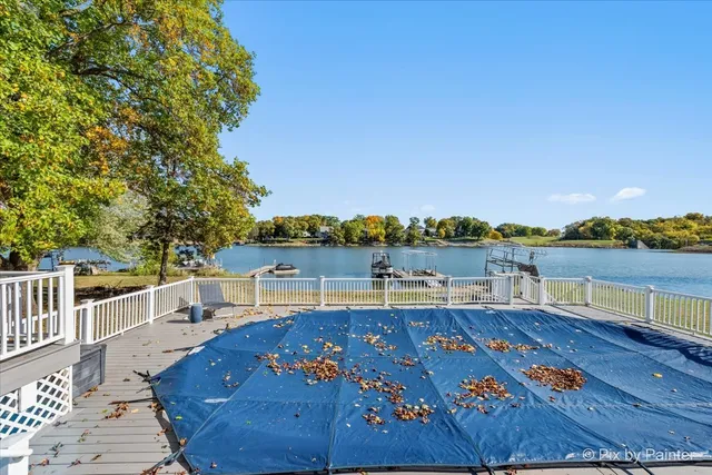a view of a balcony with lake view and wooden floor