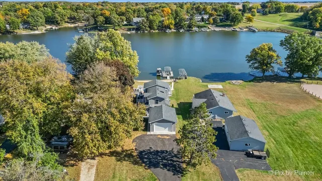 an aerial view of a house with a lake view