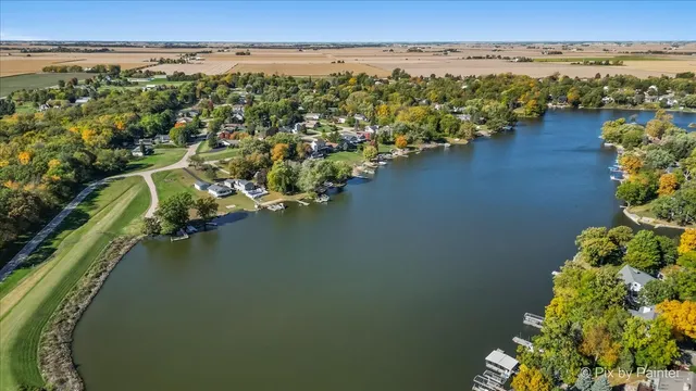 an aerial view of a house with a yard lake view