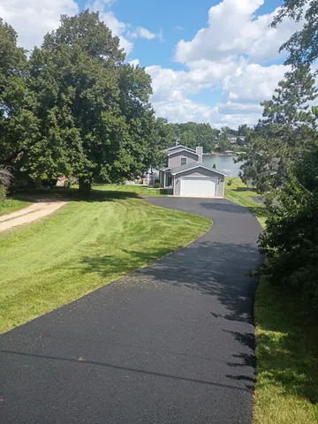 a view of a swimming pool with an outdoor seating and a yard