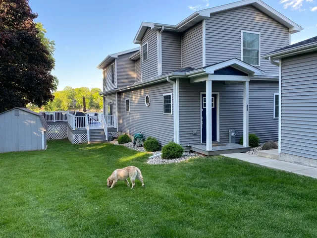 a front view of house with yard and outdoor seating