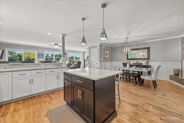 a kitchen with stainless steel appliances granite countertop stove top oven and cabinets