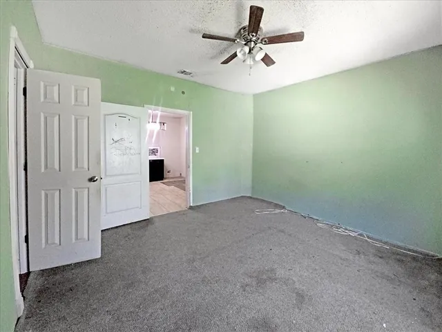 a view of a livingroom with a chandelier fan and a chandelier fan