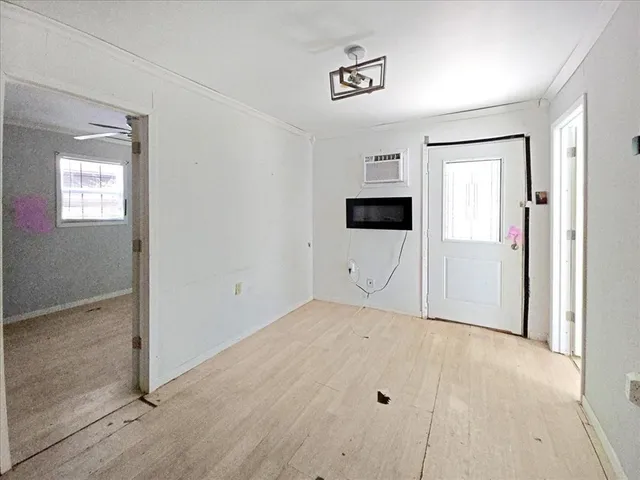 a view of empty room with wooden floor