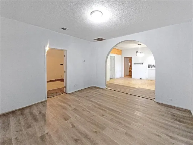 a view of a room with wooden floor and a window