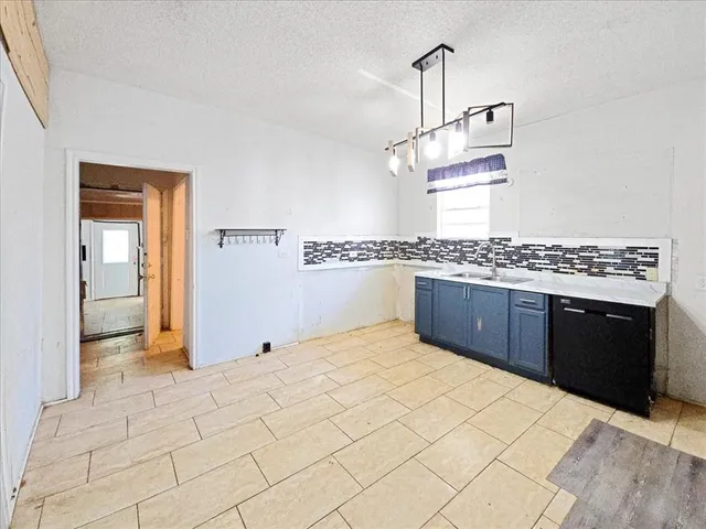 a kitchen with stainless steel appliances a sink and cabinets