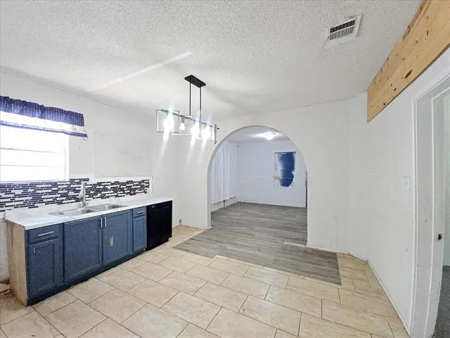 a kitchen with a stove and a refrigerator