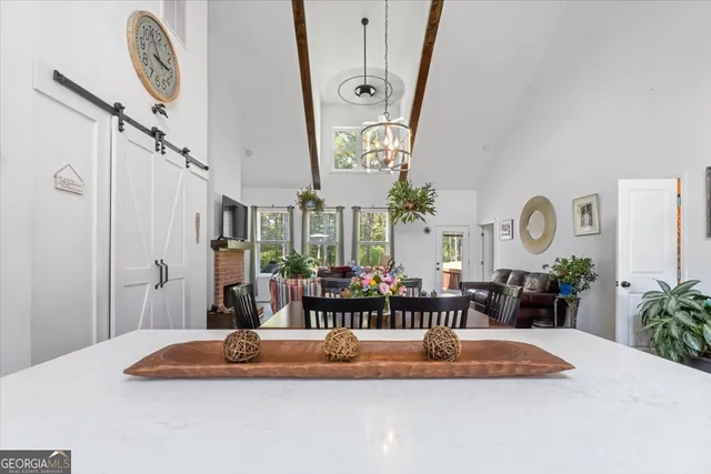 a very nice looking room with a large window and chandelier