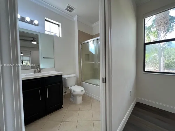 a bathroom with a sink vanity and a toilet