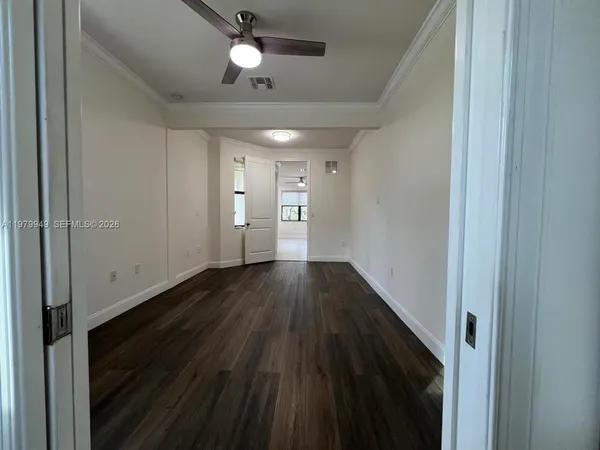 a view of hallway with wooden floor