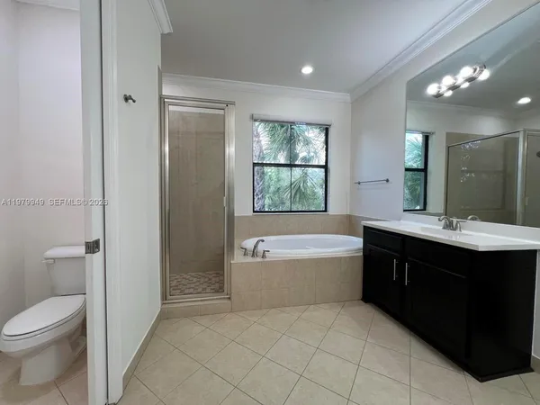 a white toilet sitting next to a shower