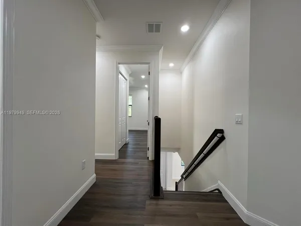 a view of a hallway with a wooden floor