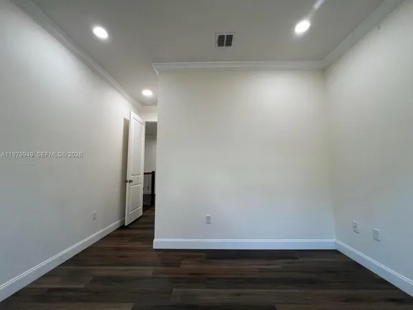 a view of hallway with wooden floor