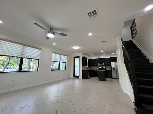a view of a livingroom with furniture and staircase
