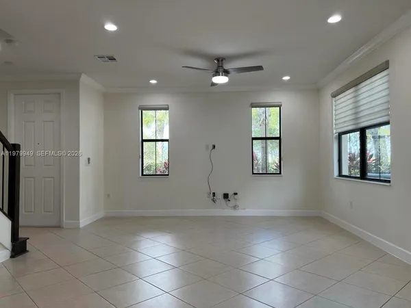 an empty room with windows and closet