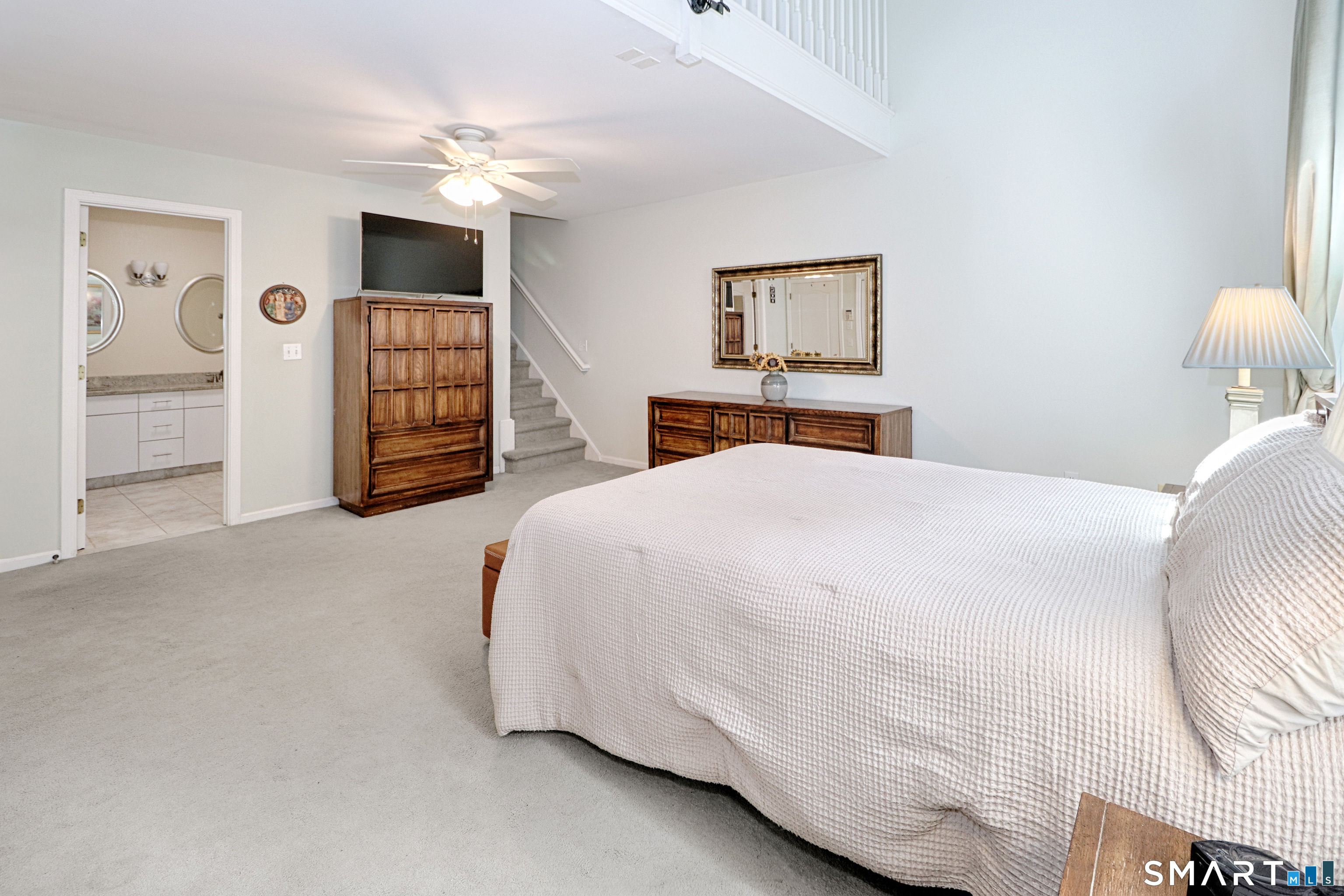 415 Pitkin Hollow, Unit 415 Trumbull, CT 06611 - Photo 15 of 35 Primary bedroom with stairs leading to office upstairs
