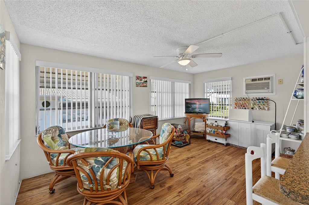 9238 140th Lane Seminole, FL 33776 - Photo 15 of 36 a living room with furniture a flat screen tv and a table