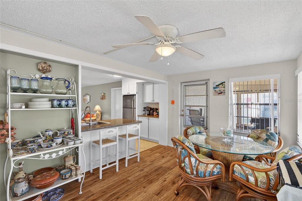 9238 140th Lane Seminole, FL 33776 - Photo 17 of 36 a view of a dining room with furniture and wooden floor