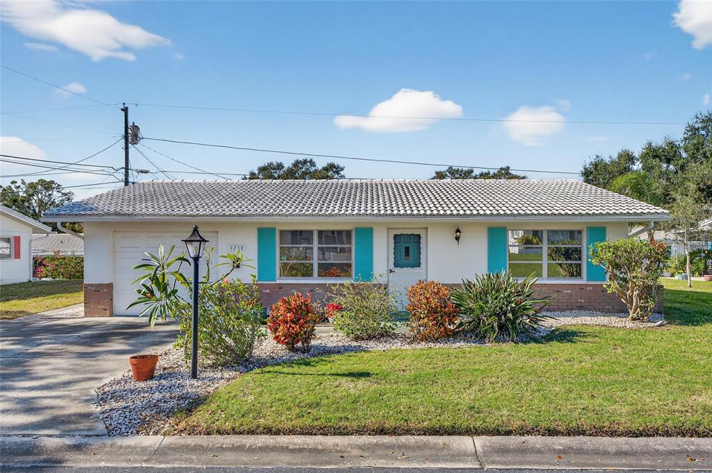9238 140th Lane Seminole, FL 33776 - Photo 2 of 36 a front view of a house with garden