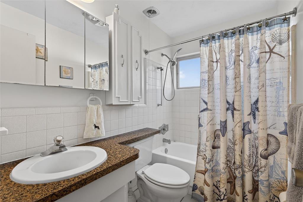 9238 140th Lane Seminole, FL 33776 - Photo 24 of 36 a bathroom with a sink toilet a shower and a mirror