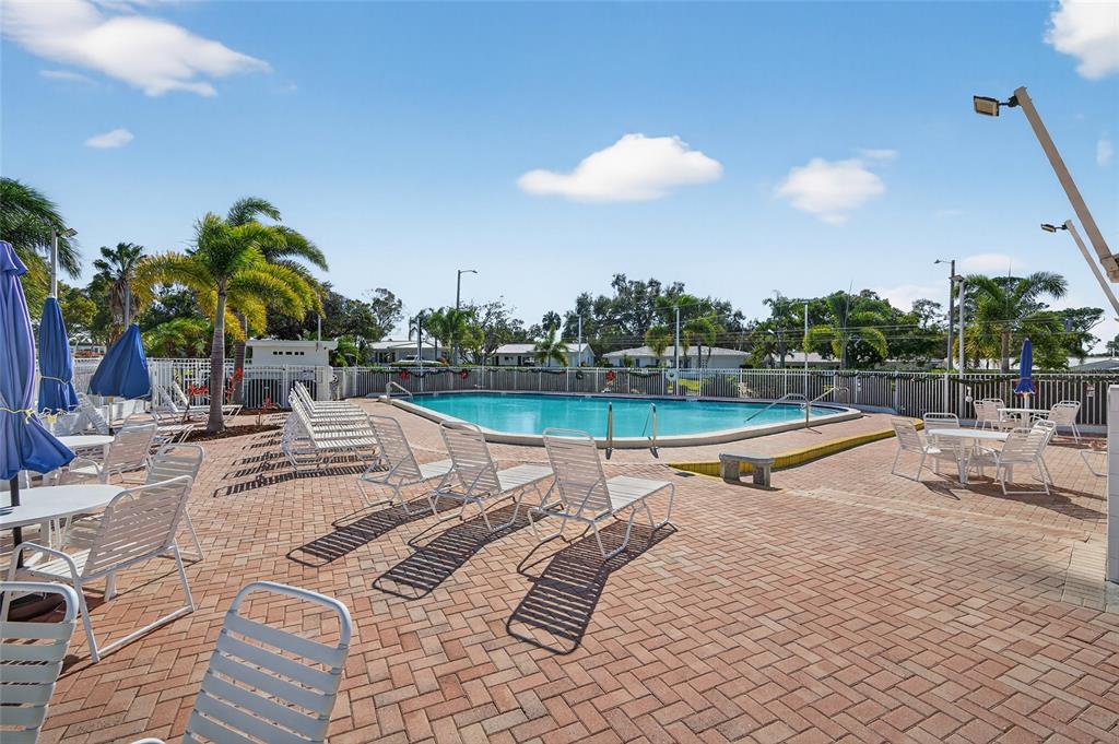 9238 140th Lane Seminole, FL 33776 - Photo 31 of 36 a view of a swimming pool with lounge chairs