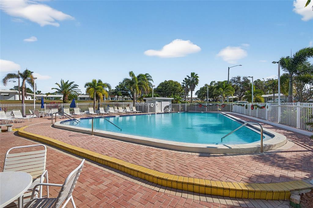 9238 140th Lane Seminole, FL 33776 - Photo 32 of 36 a view of a swimming pool with outdoor seating