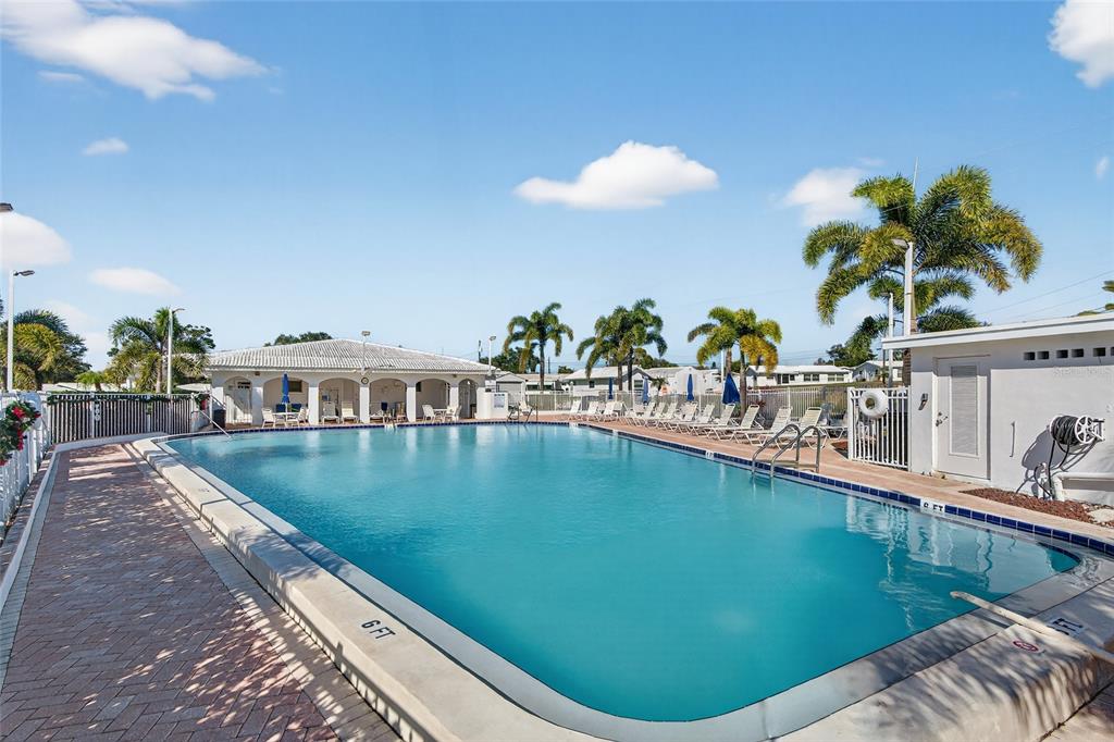 9238 140th Lane Seminole, FL 33776 - Photo 33 of 36 a view of a swimming pool with a lounge chair