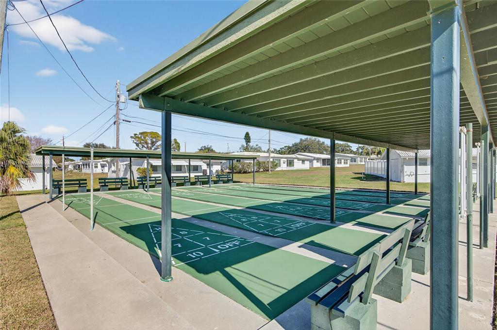 9238 140th Lane Seminole, FL 33776 - Photo 36 of 36 a view of a backyard with table and chairs with wooden floor and fence