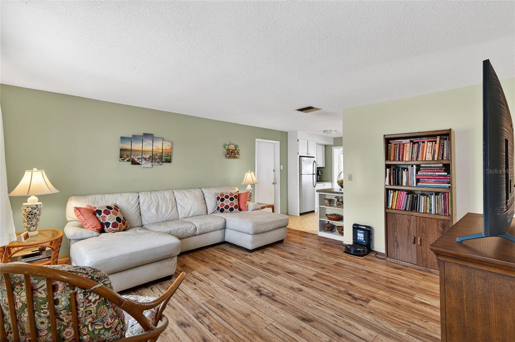 9238 140th Lane Seminole, FL 33776 - Photo 7 of 36 a living room with furniture and a wooden floor