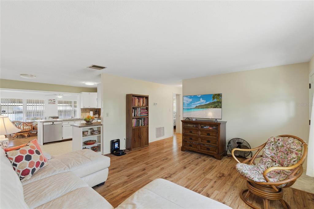 9238 140th Lane Seminole, FL 33776 - Photo 8 of 36 a living room with furniture and a flat screen tv