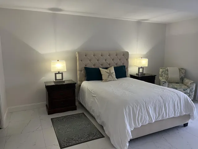 a bedroom with a bed and a lamp
