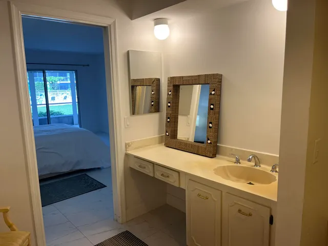 a en suite bathroom with a sink and a mirror