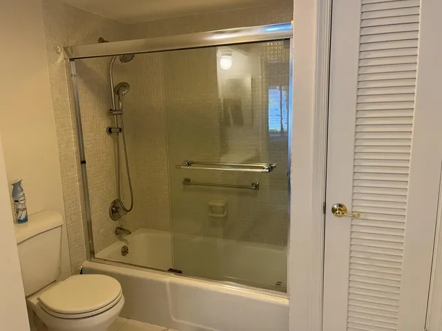 a bathroom with a shower and a toilet