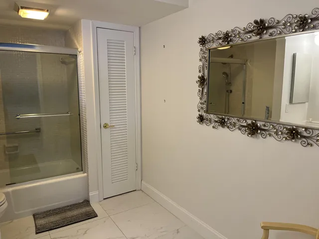 a bathroom with a bathtub and shower