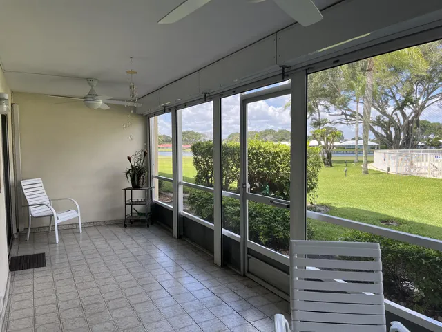 a room with lawn chairs and a large window