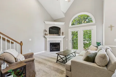 a living room with furniture fireplace and window