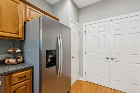 a kitchen with a refrigerator and cabinets